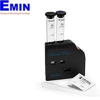 Technician inspecting an iron content meter used for water and environmental measurement